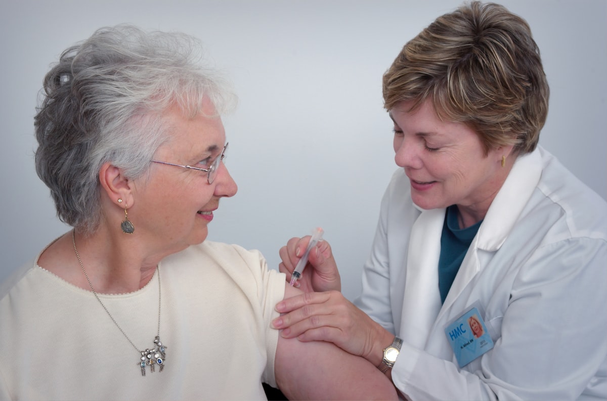 Professional caregiver reviewing medical records with a patient